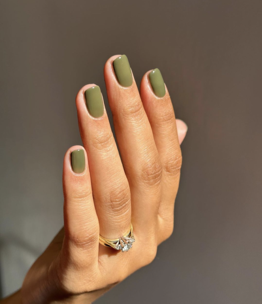 image of a woman's hand with a chic nails that are olive green