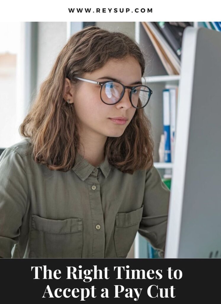 Woman looking at the computer trying to determine the right times to accept a pay cut.